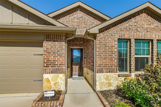 doorway to property with a garage