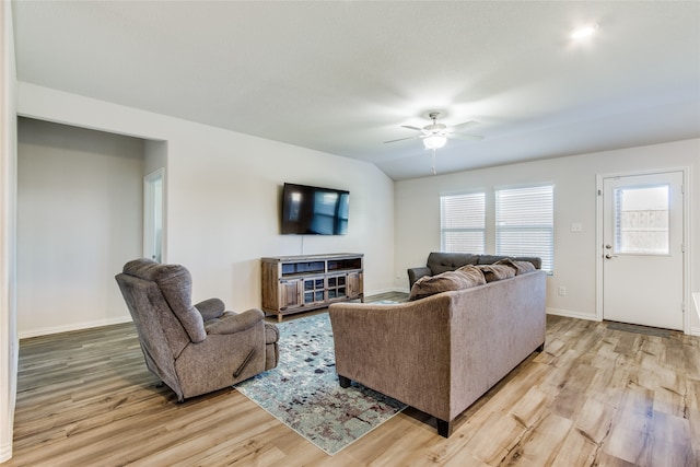 living room with ceiling fan, a wealth of natural light, and light hardwood / wood-style flooring