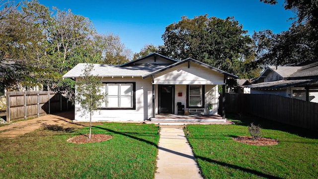 bungalow-style house with covered porch and a front lawn