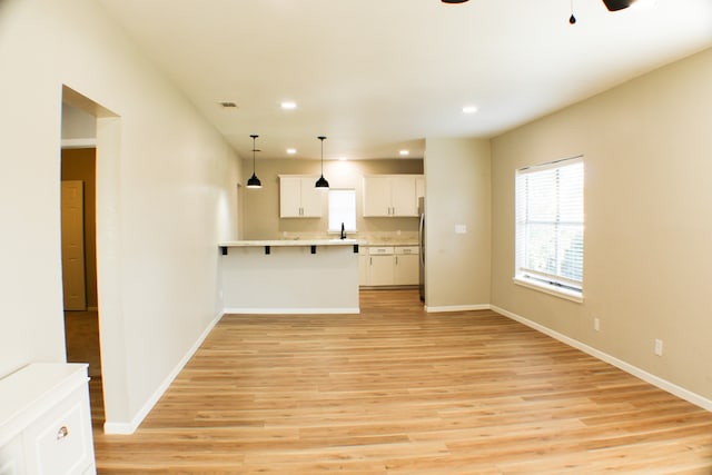 unfurnished living room with light hardwood / wood-style flooring and sink