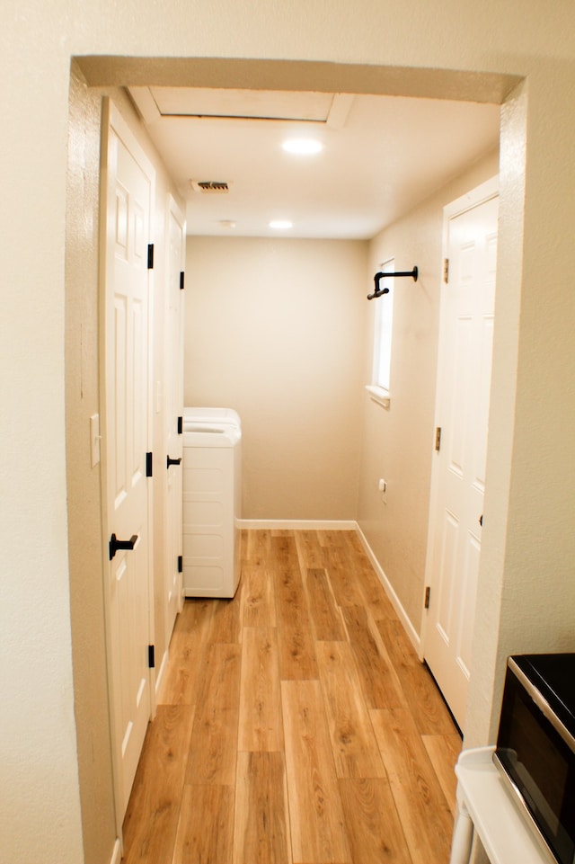 hallway with light hardwood / wood-style flooring