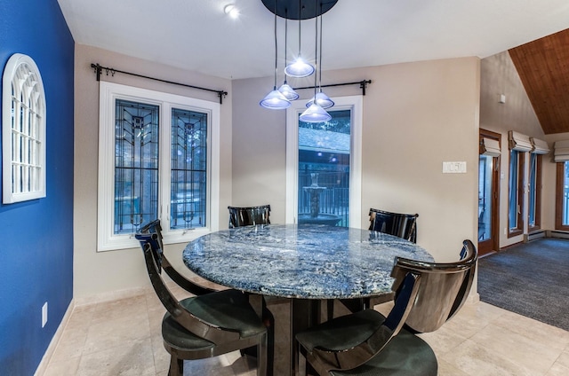 tiled dining space featuring vaulted ceiling