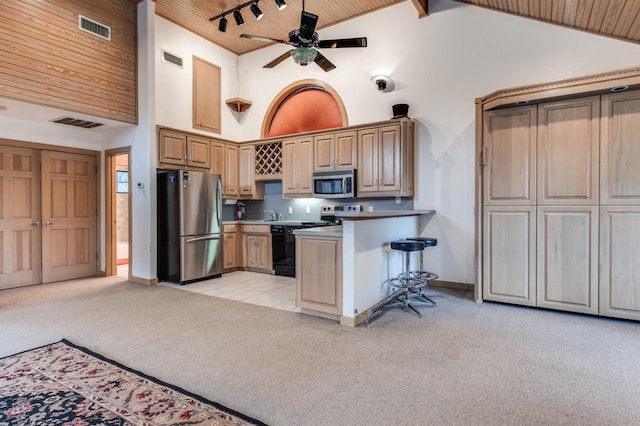 kitchen featuring wooden ceiling, high vaulted ceiling, stainless steel appliances, and light carpet