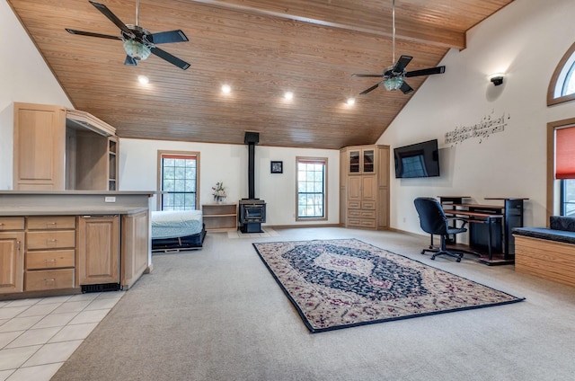 tiled office with ceiling fan, wood ceiling, high vaulted ceiling, and a wood stove