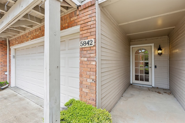 doorway to property featuring a garage