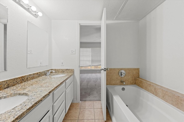 bathroom with vanity, tile patterned floors, and a bathtub