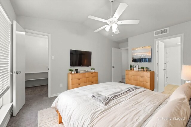 bedroom featuring ceiling fan, light carpet, and vaulted ceiling