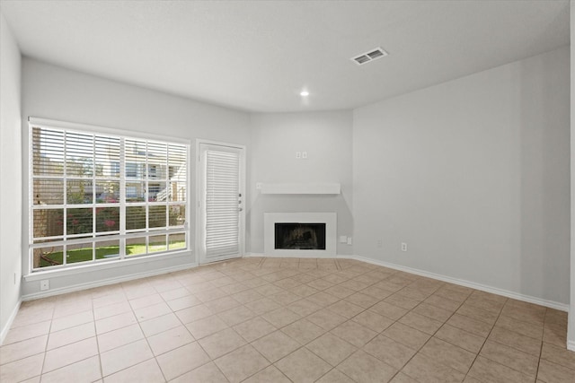 unfurnished living room with light tile patterned flooring