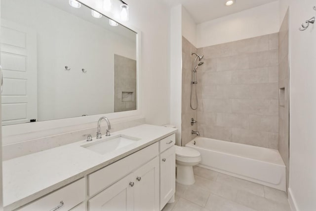 full bathroom featuring tile patterned floors, toilet, tiled shower / bath combo, and vanity