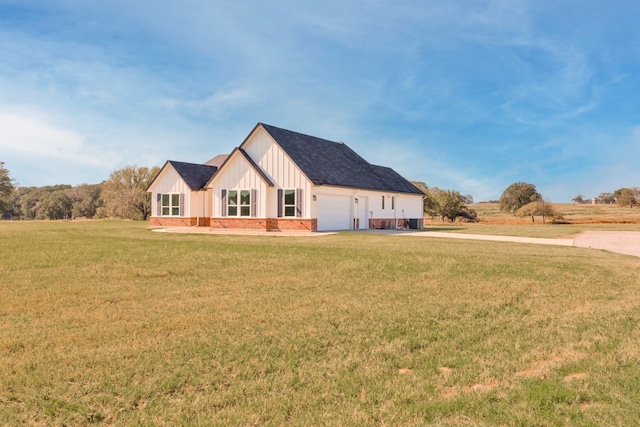 view of front of home with a front lawn and a garage