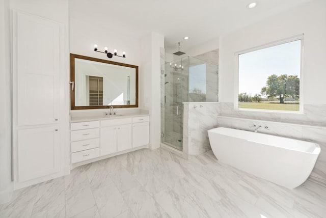 bathroom with vanity, independent shower and bath, and tile walls