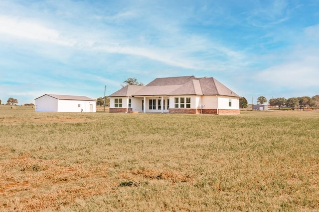 back of house with a lawn