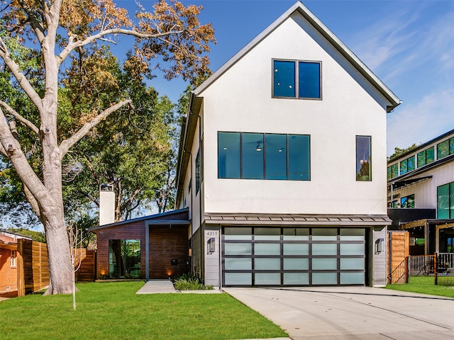 contemporary house featuring a garage and a front yard