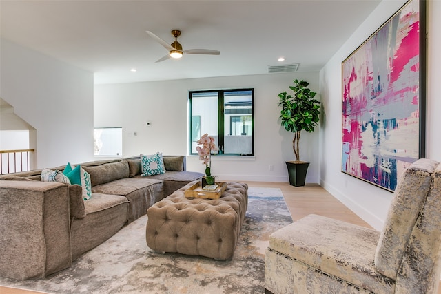 living room featuring ceiling fan and light hardwood / wood-style flooring