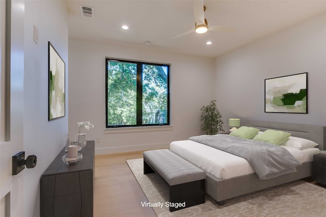 bedroom with light hardwood / wood-style flooring and ceiling fan