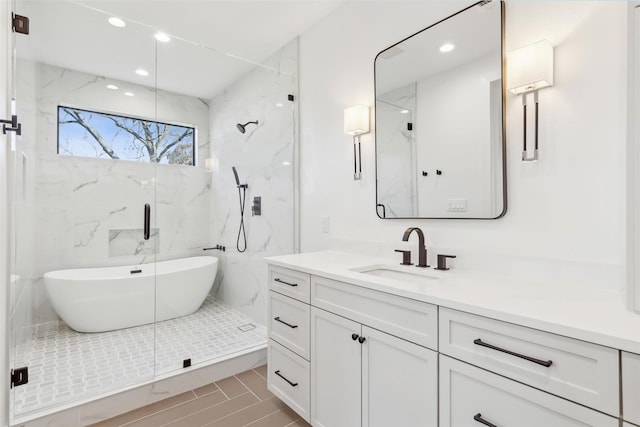 bathroom with vanity and independent shower and bath