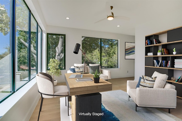 interior space featuring ceiling fan and plenty of natural light