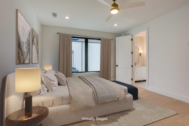 bedroom with ceiling fan, connected bathroom, and light hardwood / wood-style flooring