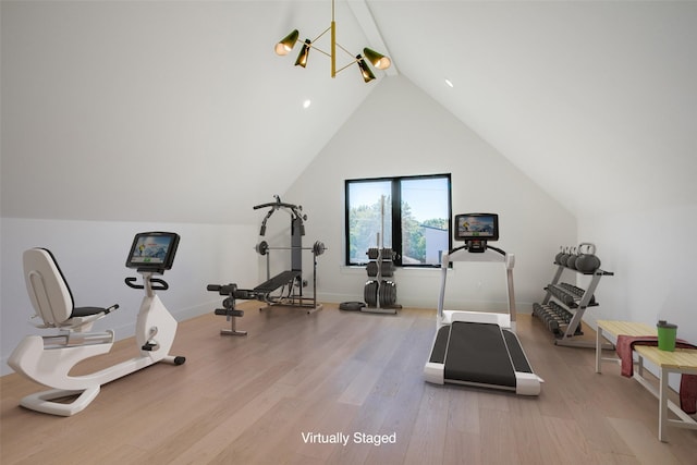 workout room with wood-type flooring and lofted ceiling