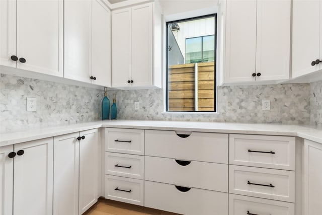 kitchen with white cabinetry and decorative backsplash