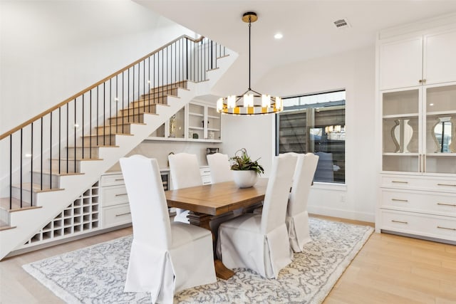 dining room with a notable chandelier and light hardwood / wood-style floors