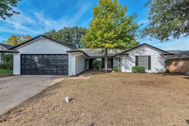 ranch-style house featuring a garage and a front yard