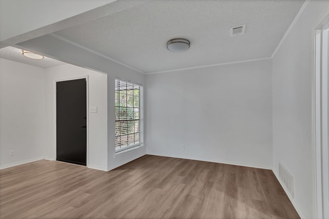 unfurnished room featuring crown molding, a textured ceiling, and light hardwood / wood-style flooring