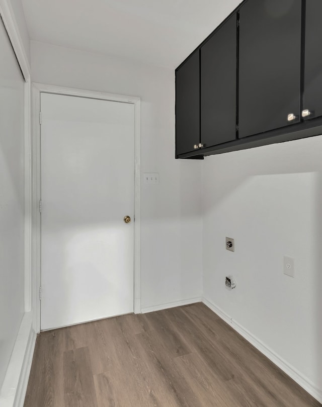 washroom with light hardwood / wood-style floors, cabinets, and hookup for an electric dryer