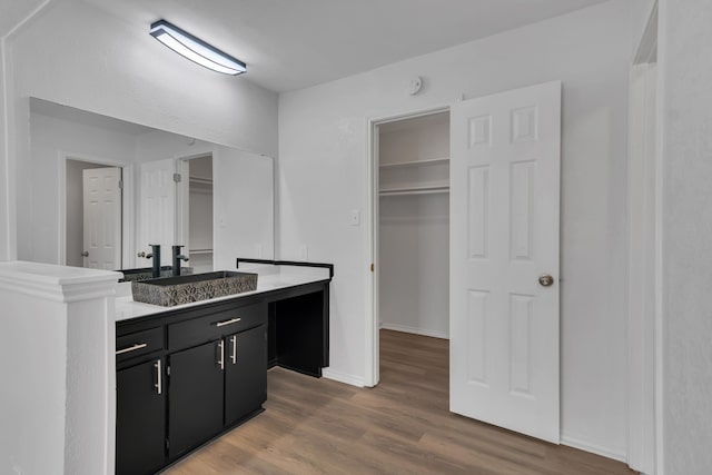 interior space with vanity and hardwood / wood-style flooring