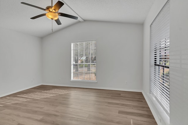 unfurnished room with a textured ceiling, ceiling fan, light hardwood / wood-style flooring, and vaulted ceiling