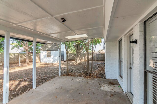 view of patio featuring a shed