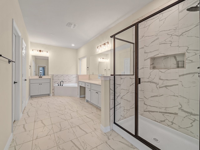 bathroom featuring vanity and shower with separate bathtub