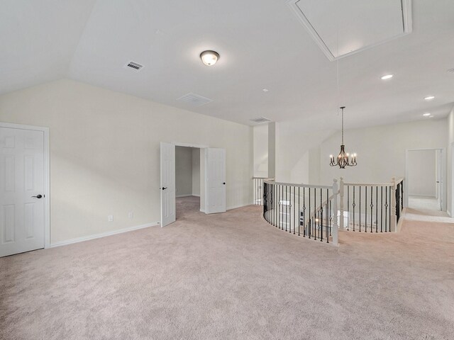 carpeted spare room with lofted ceiling