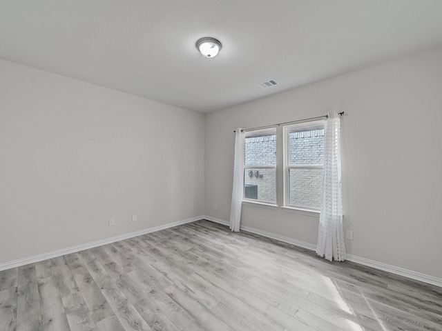 spare room with light wood-type flooring