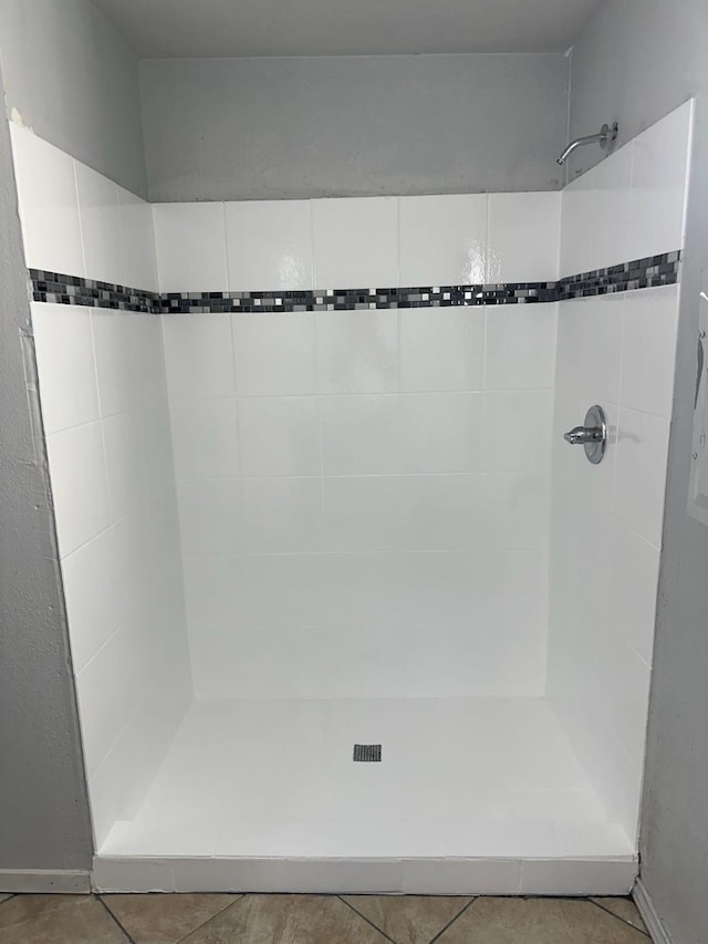 bathroom with tile patterned floors and walk in shower