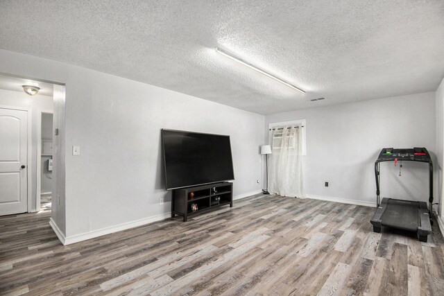 dining space featuring an AC wall unit and light hardwood / wood-style floors