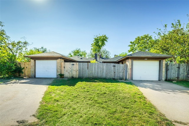 single story home with a garage and a front lawn