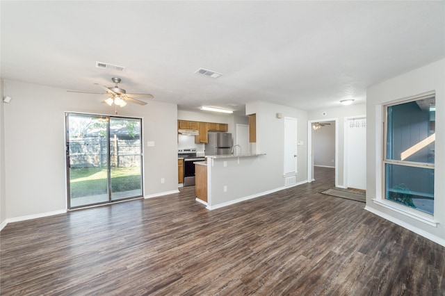 unfurnished living room with ceiling fan, dark wood-type flooring, and sink
