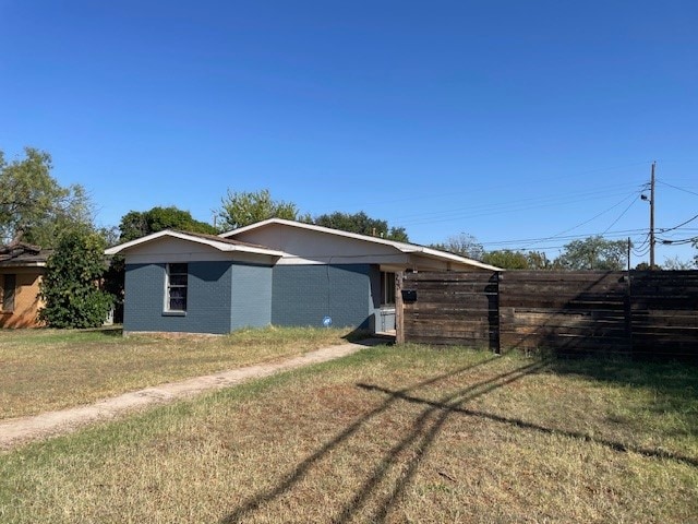 rear view of property featuring a yard