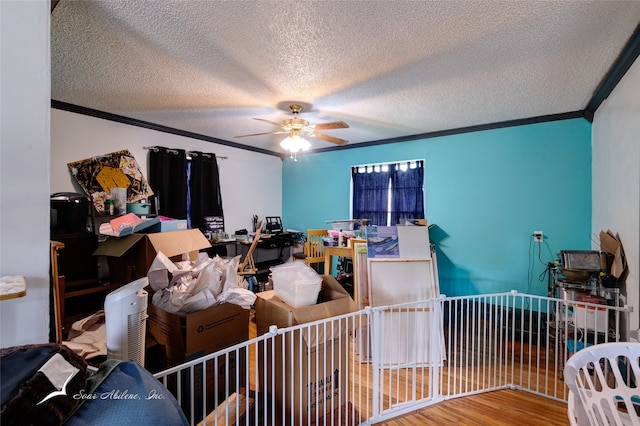 bedroom with hardwood / wood-style floors, a textured ceiling, and ornamental molding