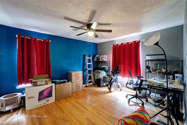 office area with hardwood / wood-style floors, ceiling fan, and a textured ceiling