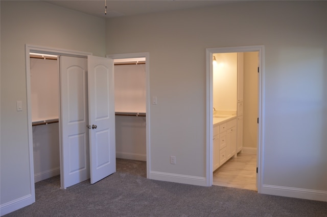 unfurnished bedroom with light colored carpet and ensuite bathroom