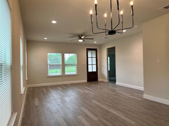 interior space featuring recessed lighting, visible vents, ceiling fan with notable chandelier, and dark wood-type flooring