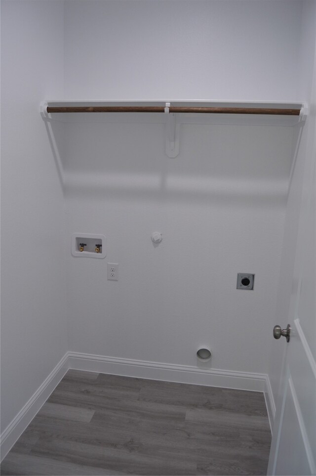 clothes washing area featuring gas dryer hookup, washer hookup, dark hardwood / wood-style floors, and hookup for an electric dryer