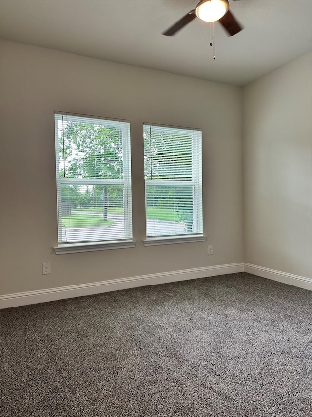spare room featuring baseboards, carpet flooring, and a ceiling fan