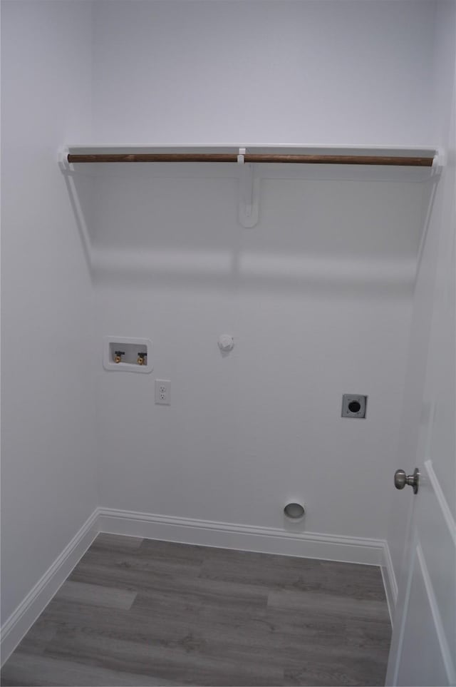 clothes washing area with laundry area, electric dryer hookup, hookup for a gas dryer, wood finished floors, and hookup for a washing machine