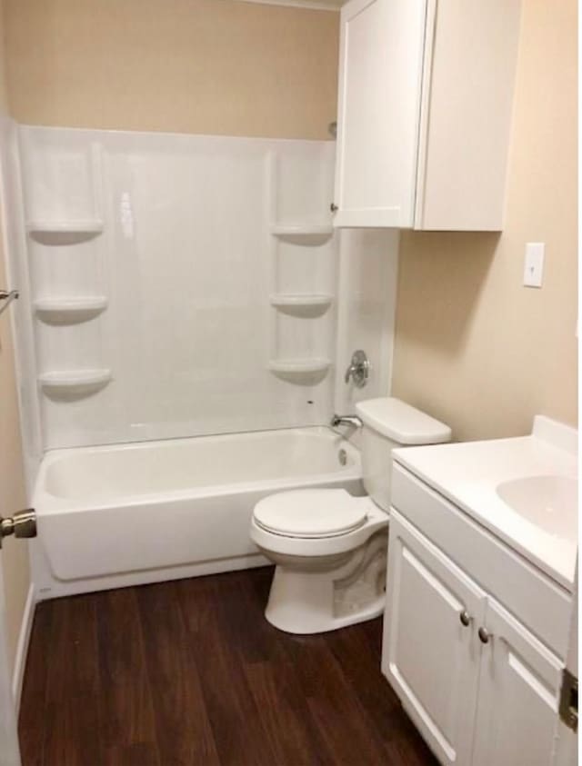 full bathroom featuring hardwood / wood-style floors, vanity, shower / bath combination, and toilet