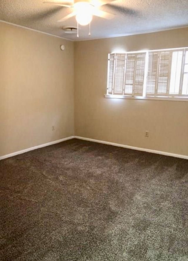 carpeted empty room featuring a textured ceiling and ceiling fan