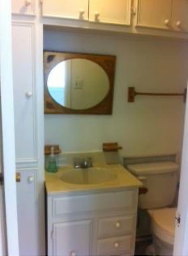 bathroom featuring vanity and toilet