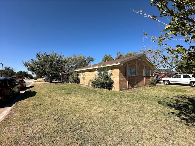 view of side of property featuring a yard